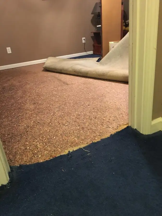 Carpet pad removal revealing water damage during Drying & Dehumidification in Emmett
